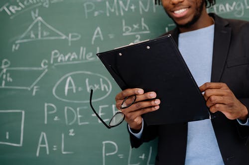 A teacher in front of a blackboard